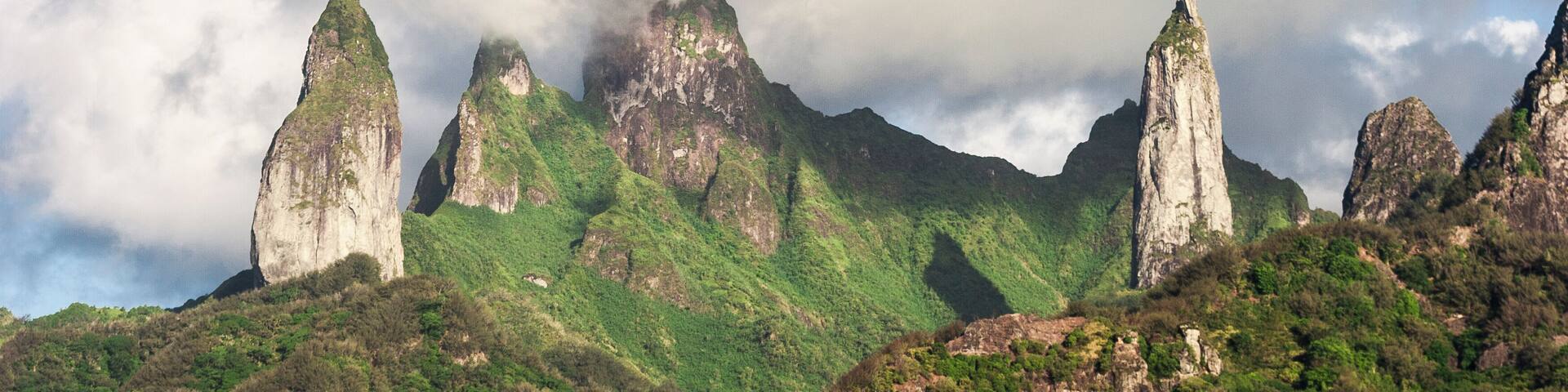 approaching Ua Pou Island from sea, Marquesas Archipelago, French Polynesia, spectacular landscape with extremely steep mountains