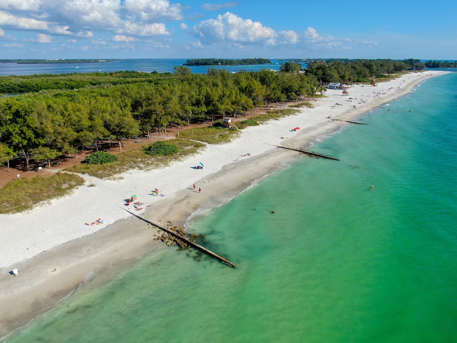 Aerial view of Coquina Beach white sand beach and turquoise water in Bradenton Beach during blue summer day, Anna Maria Island, Florida. USA