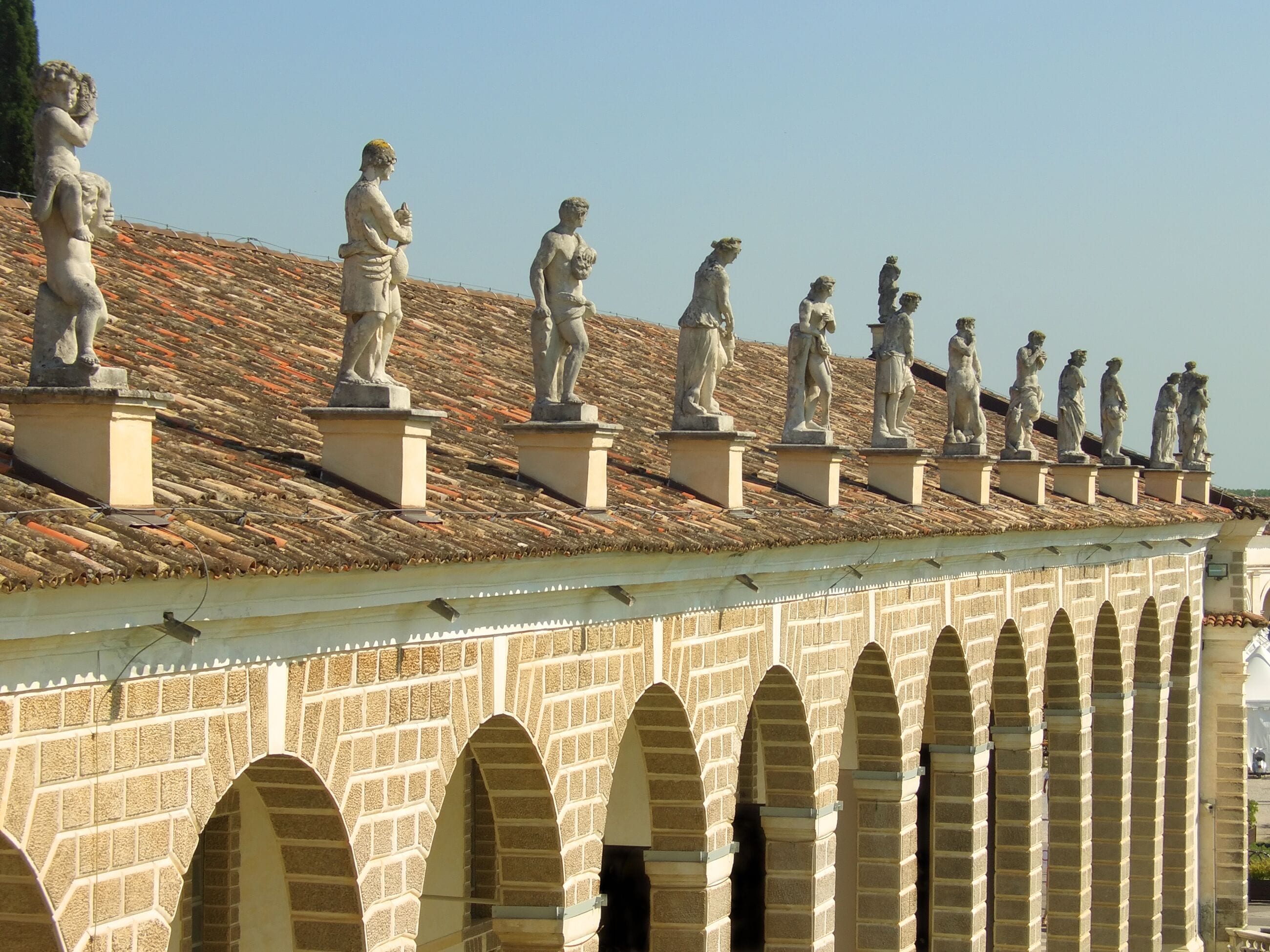Rows of classic style statues above Villa Manin porch, Udine, Italy