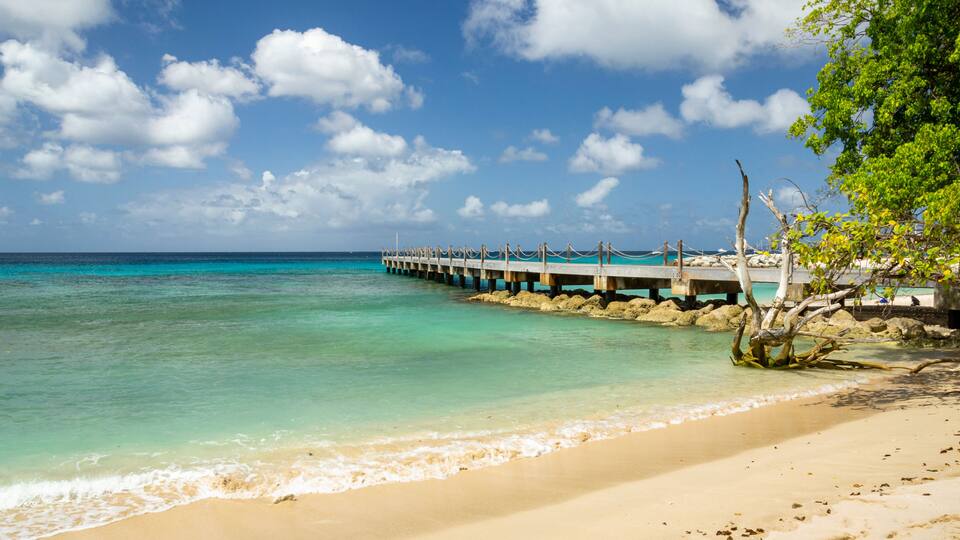 Wooden pier walkway on a beach with turquoise sea at Speightstown Barbados
