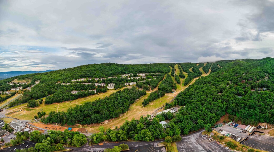 A mountainous landscape with a residential area and a parking lot.