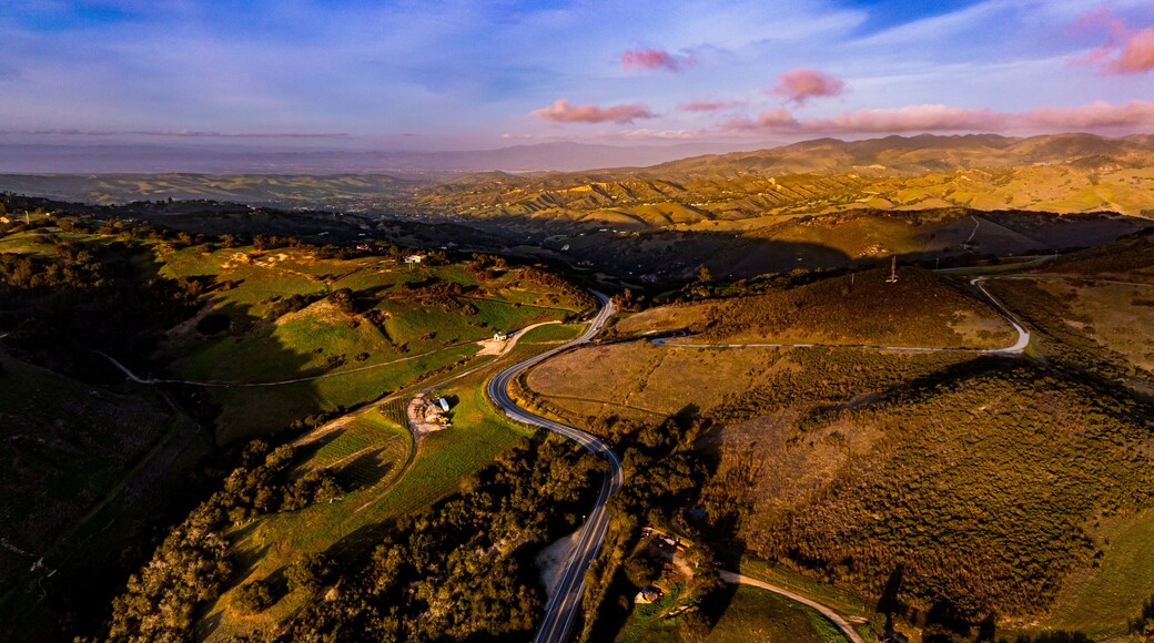 A vibrant sunset paints the winter sky above Salinas Valley and greater Monterey Bay area. A Carmel Valley landscape.