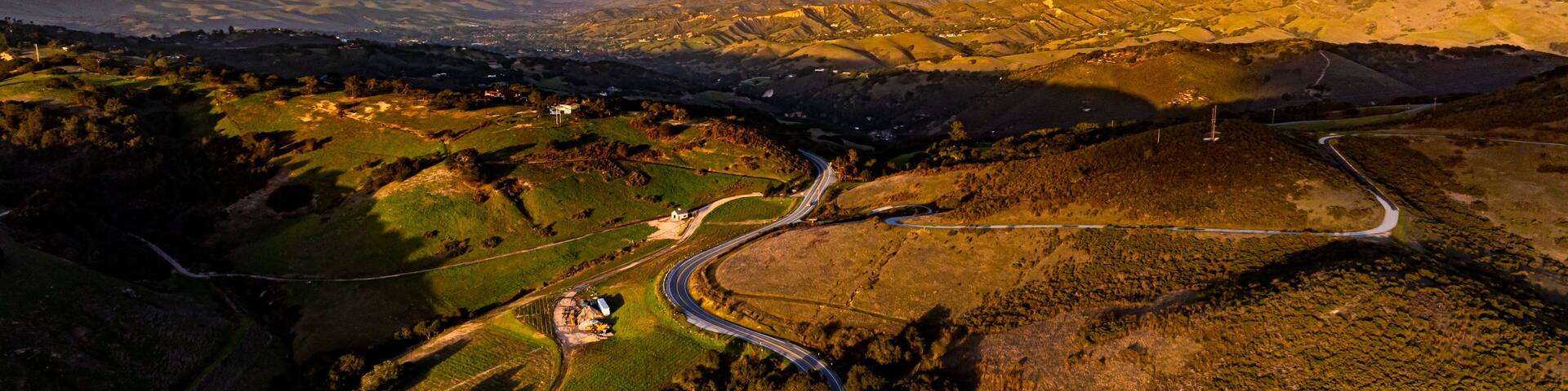 A vibrant sunset paints the winter sky above Salinas Valley and greater Monterey Bay area. A Carmel Valley landscape.