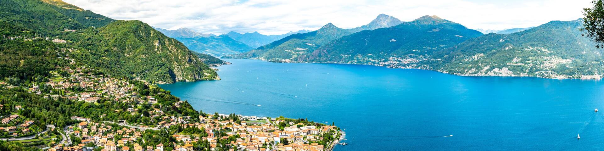 Panorama of Lake Como, photographed from the village of Croce, with the town of Menaggio and the mountains above it.