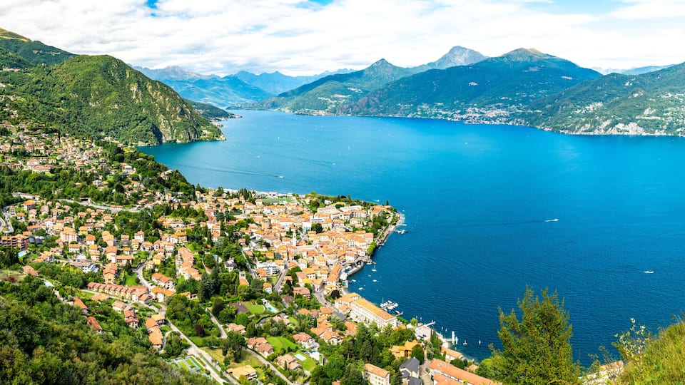 Panorama of Lake Como, photographed from the village of Croce, with the town of Menaggio and the mountains above it.