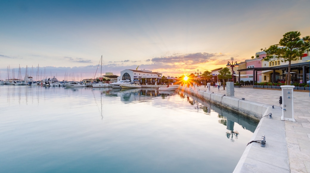 Beautiful Marina, Limassol city Cyprus. Modern, high end life in newly developed port with docked yachts, restaurants, shops, a landmark for waterfront promenade. View of the commercial area at sunset