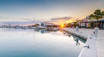 Beautiful Marina, Limassol city Cyprus. Modern, high end life in newly developed port with docked yachts, restaurants, shops, a landmark for waterfront promenade. View of the commercial area at sunset