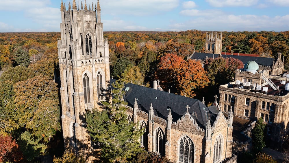 Aerial rear view of the tower, chapel and the Observatory on a mountain top October autumn fall day at the University of the South in Sewanee Tennessee.