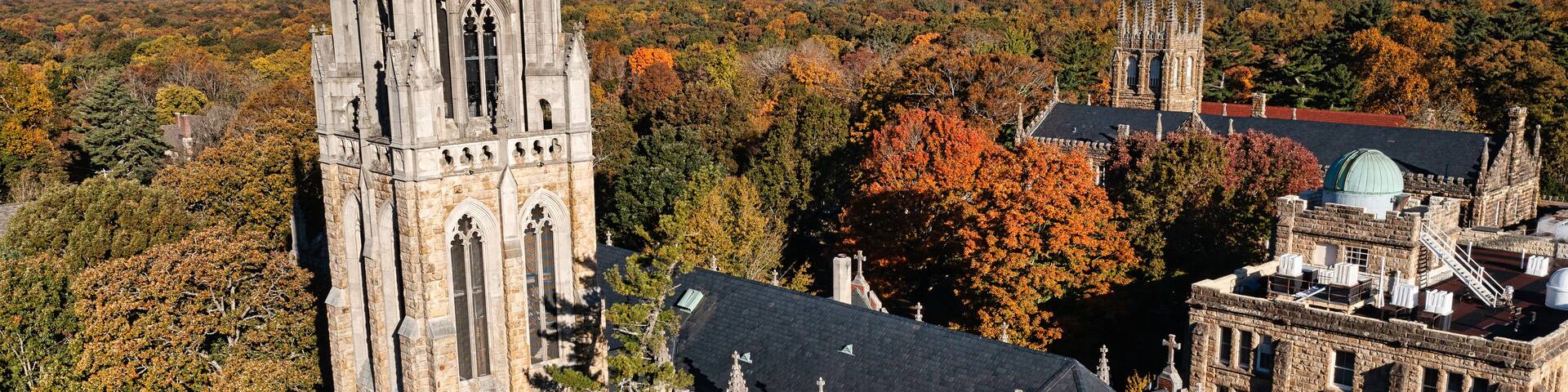 Aerial rear view of the tower, chapel and the Observatory on a mountain top October autumn fall day at the University of the South in Sewanee Tennessee.