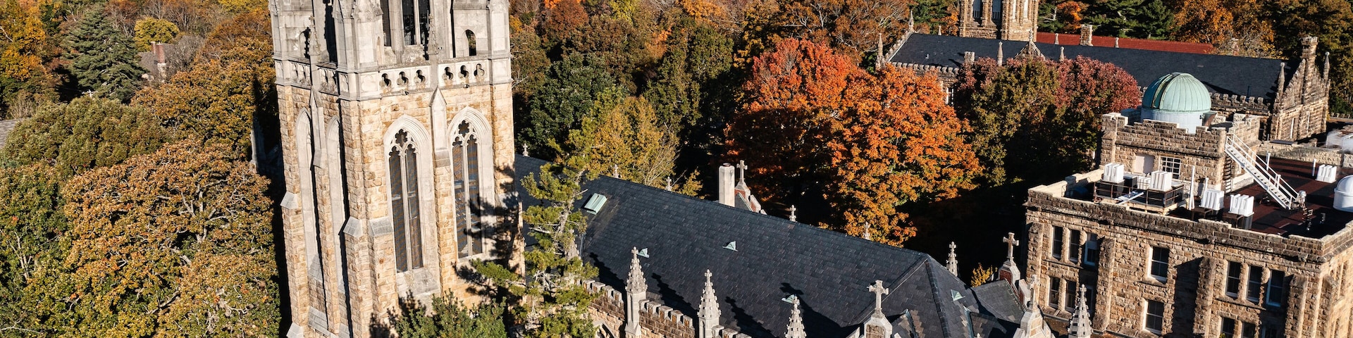 Aerial rear view of the tower, chapel and the Observatory on a mountain top October autumn fall day at the University of the South in Sewanee Tennessee.