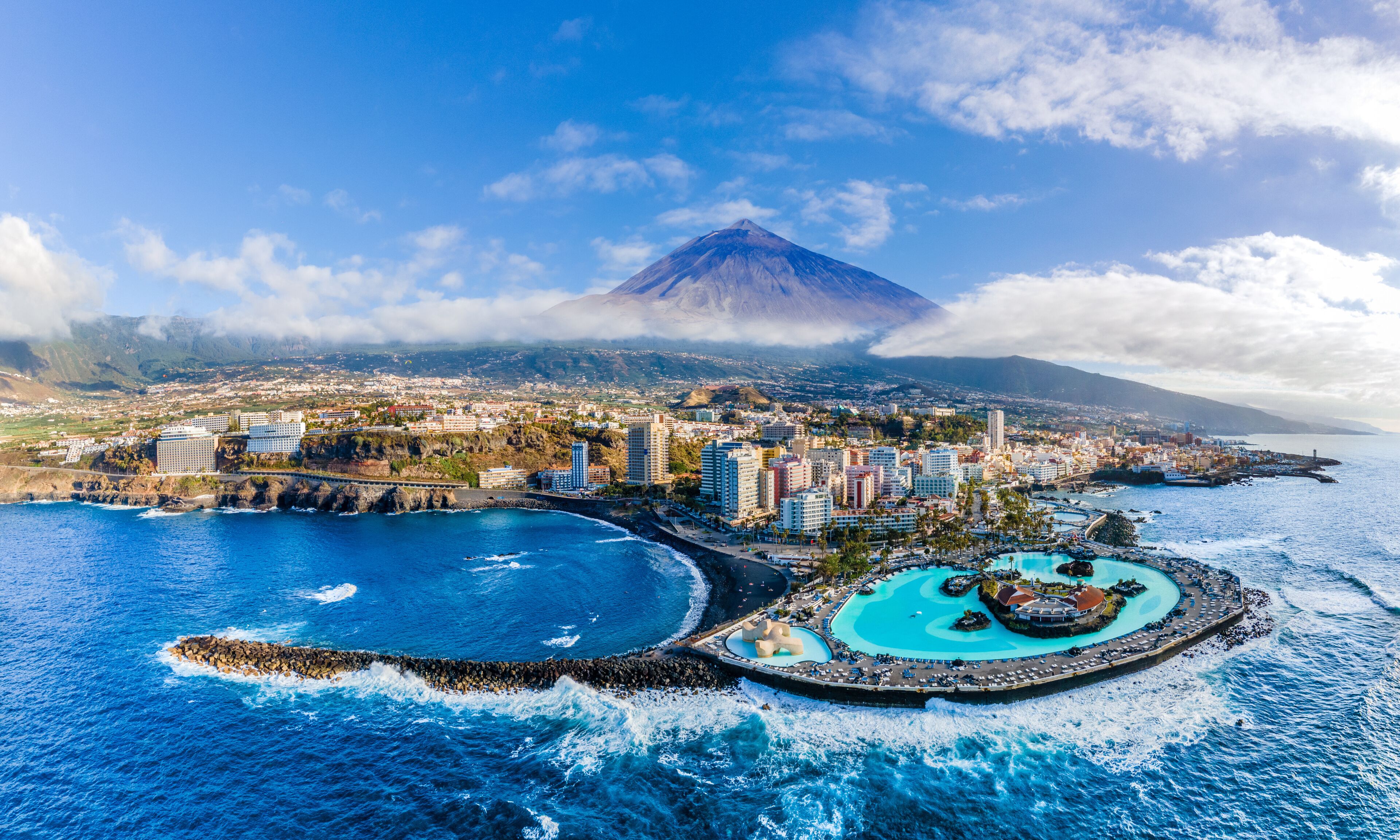 Aerial view with Puerto de la Cruz, in background Teide volcano, Tenerife island, Spain
