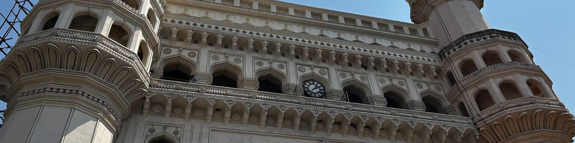 A historic building with two prominent minarets and intricate architectural details.