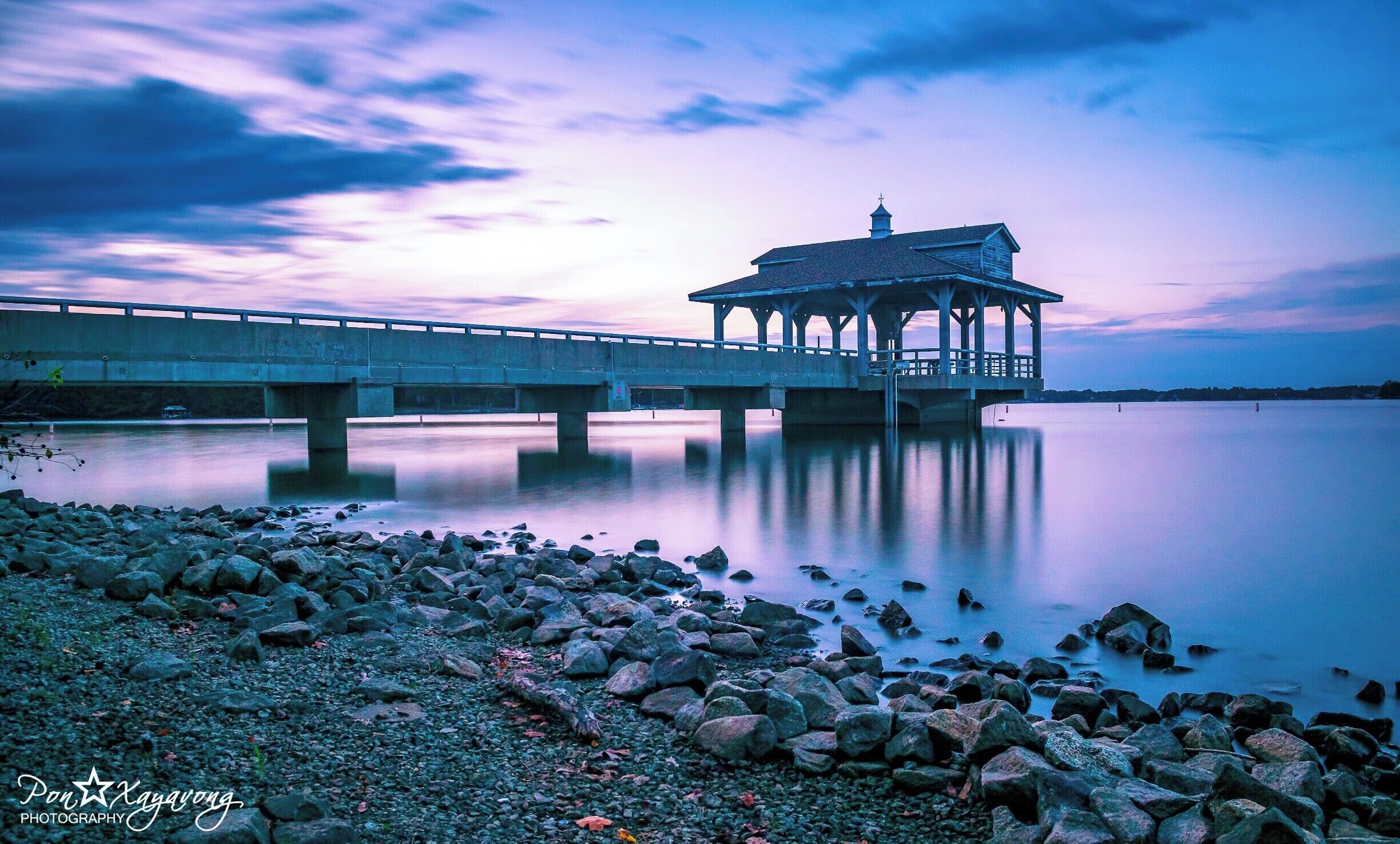 beautiful park with a nice view of the lake during sunset hour.