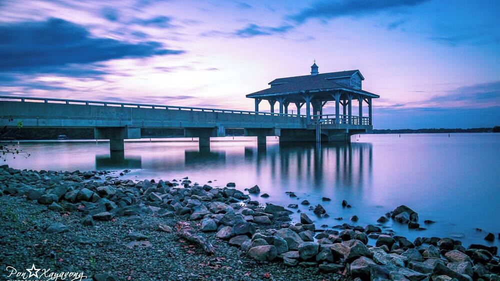 beautiful park with a nice view of the lake during sunset hour.