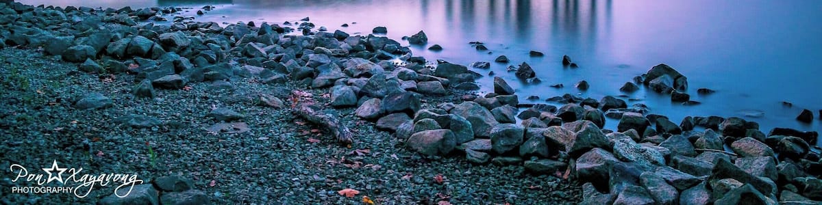 beautiful park with a nice view of the lake during sunset hour.