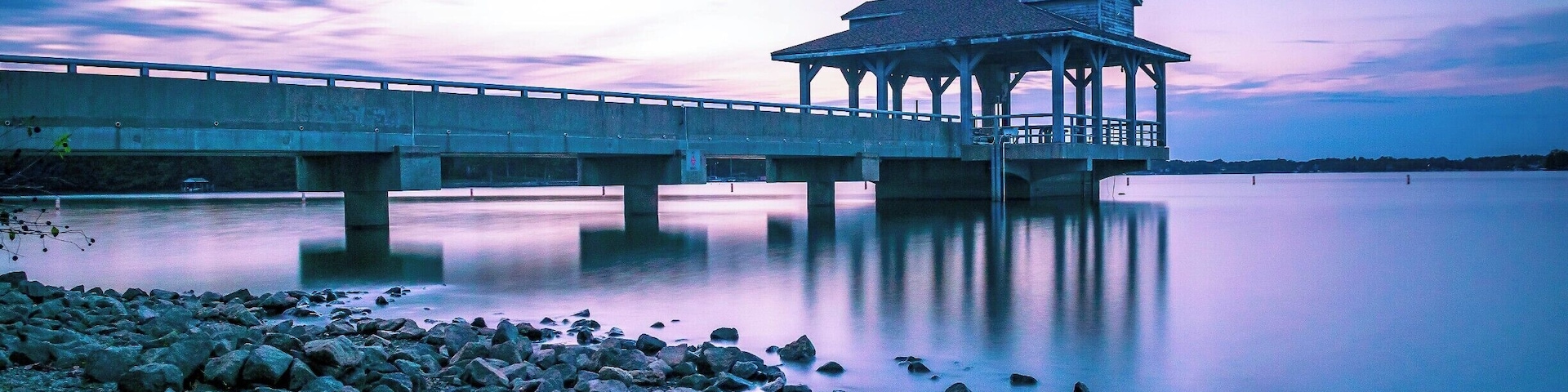 beautiful park with a nice view of the lake during sunset hour.