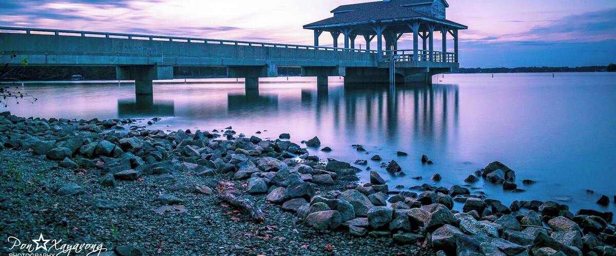 beautiful park with a nice view of the lake during sunset hour.