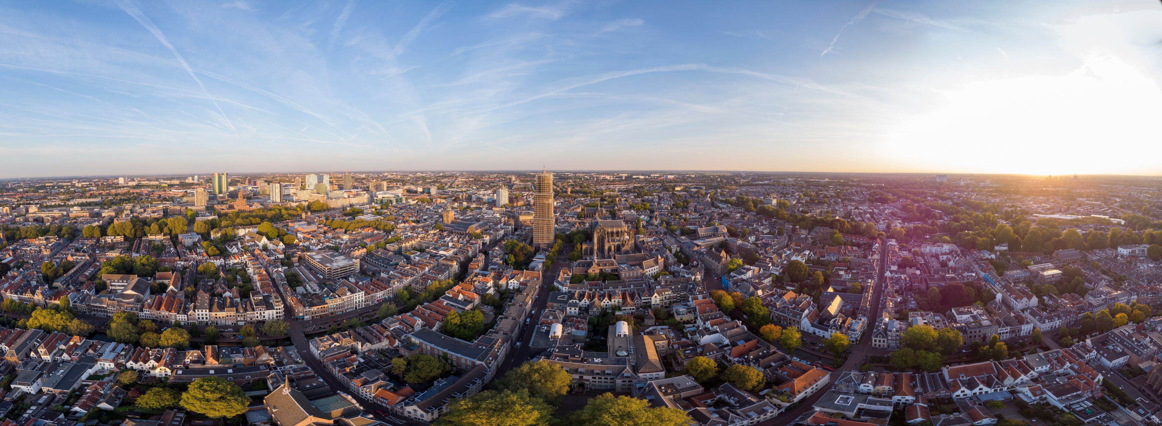 Super wide panoramic aerial view of the medieval Dutch city centre of Utrecht with cathedral towering over the city at early morning sunrise. Cityscape in The Netherlands