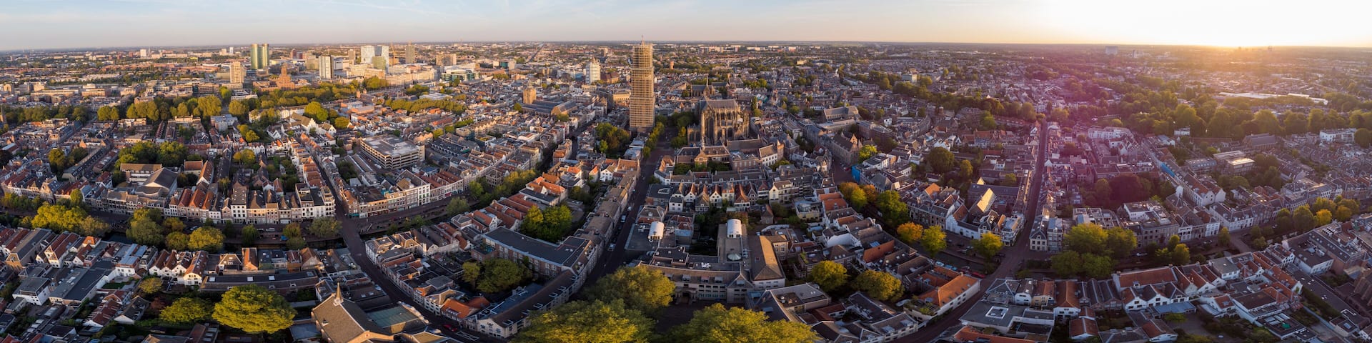 Super wide panoramic aerial view of the medieval Dutch city centre of Utrecht with cathedral towering over the city at early morning sunrise. Cityscape in The Netherlands