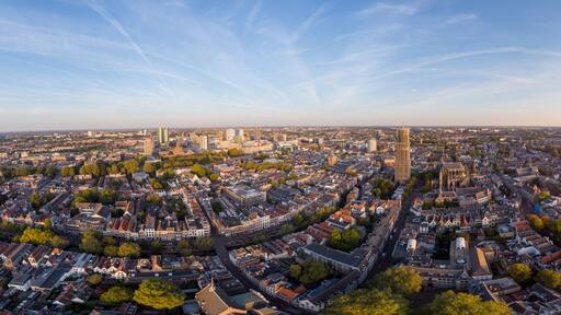 Super wide panoramic aerial view of the medieval Dutch city centre of Utrecht with cathedral towering over the city at early morning sunrise. Cityscape in The Netherlands