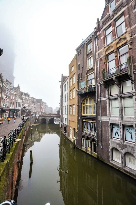 Canal side buildings in a misty Utrecht on New Year's Day.