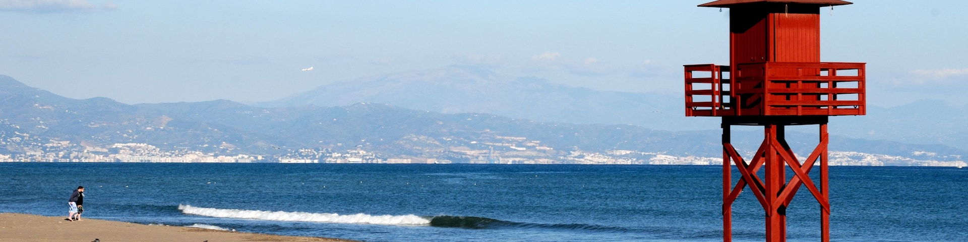 Typical red wooden watchtower for rescue workers on the beach of Torremolinos, Malaga - Spain