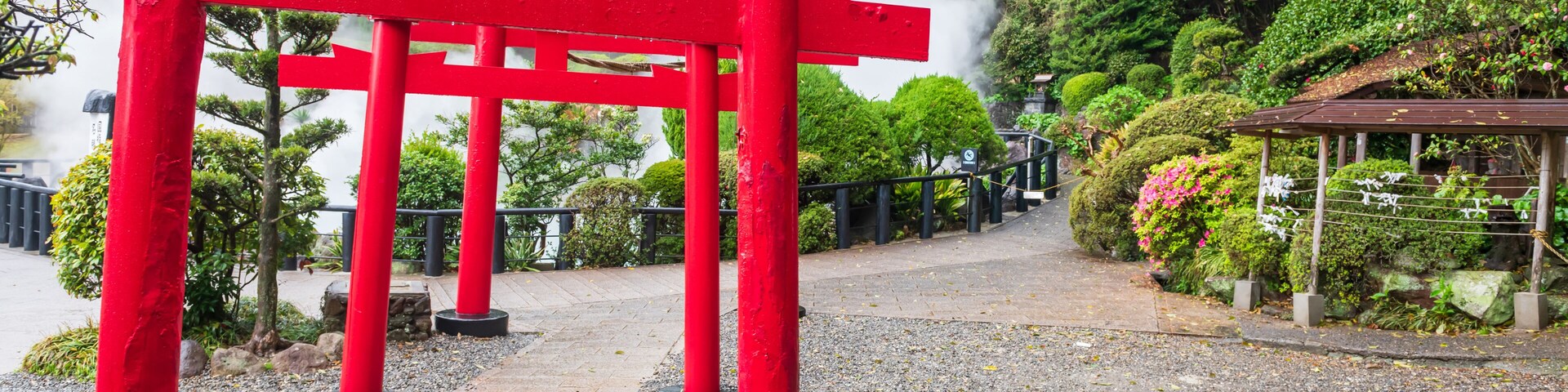 Red torii gates with white steam at Umi Sea Hell of Kamado Jigoku, Beppu
