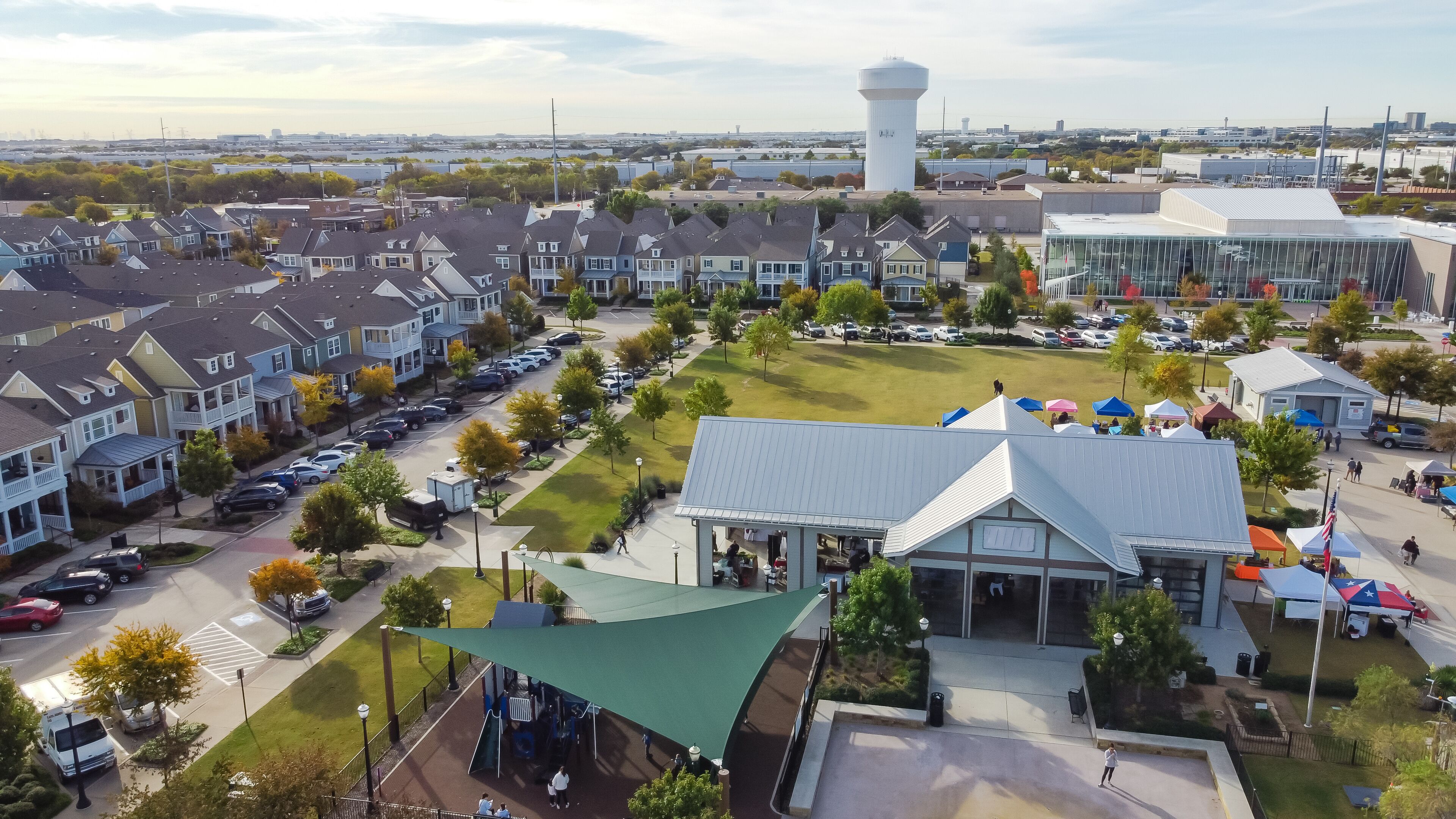 Top view Farmer Market with row of colorful tents and cottage houses at Coppell Downtown, Texas, America