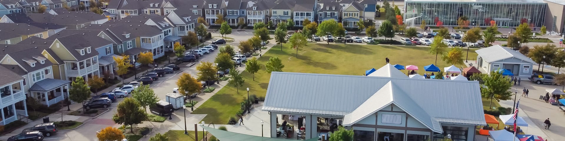 Top view Farmer Market with row of colorful tents and cottage houses at Coppell Downtown, Texas, America