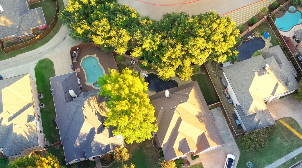 Panorama aerial view suburban houses with swimming pools and colorful fall foliage in Coppell, suburbs Dallas, Texas, large detached single-family houses, fast growing real estate housing market