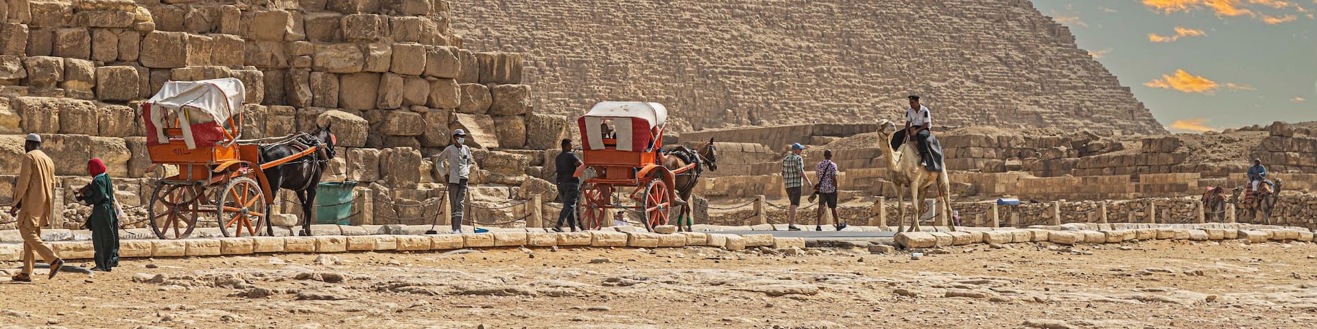 The Great Pyramid of Giza with tourists and camels.