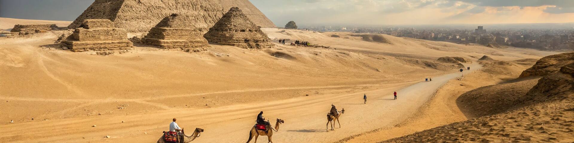 The Great Pyramids of Giza, a desert landscape, and a road with people and camels.