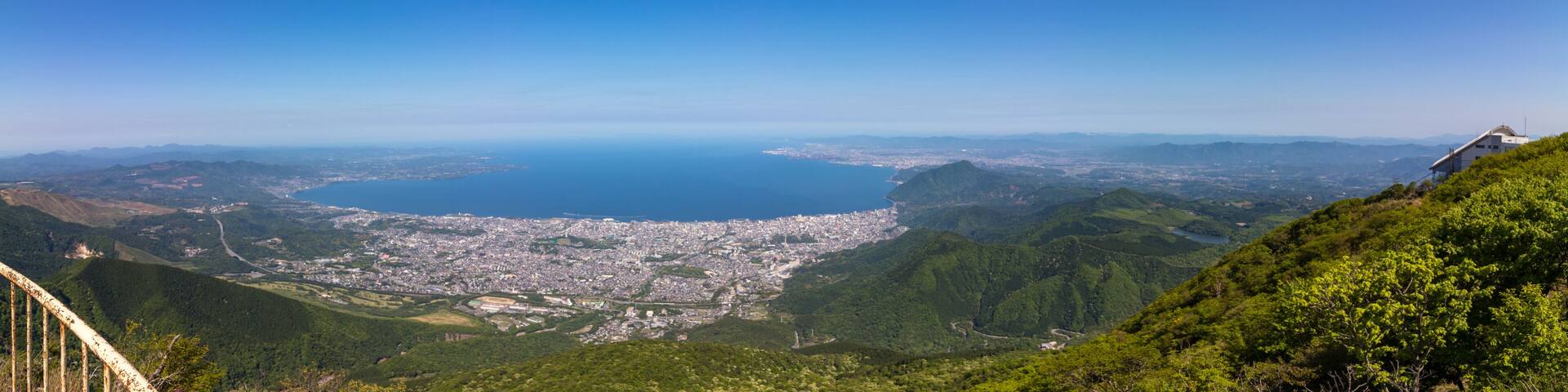 Panoramic view on Beppu City and Bay, between Mountains of Kyushu and green Landscape in the foreground from mount Tsurumi. Beppu, Oita Prefecture, Japan, Asia.