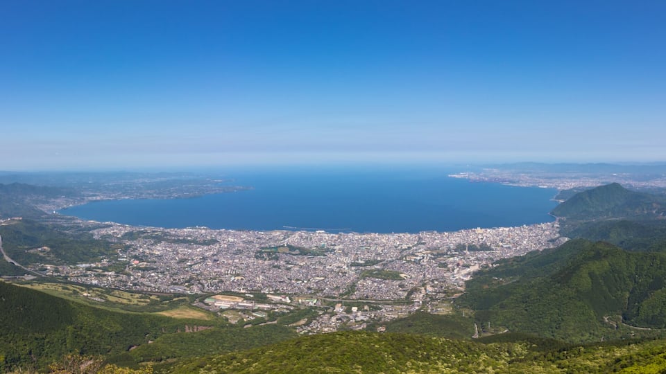 Panoramic view on Beppu City and Bay, between Mountains of Kyushu and green Landscape in the foreground from mount Tsurumi. Beppu, Oita Prefecture, Japan, Asia.