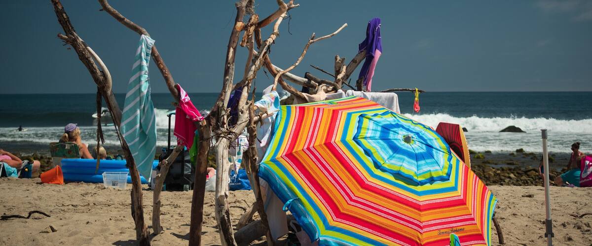 Beachfront Property. With a little driftwood and an umbrella you can be living in seaside luxury. This lean-to was the first thing that caught my eye when I stepped on the sand. If you look deeper, you will discover a grab bag of beach goodies in this shot. #trovember #malibu #beach #california