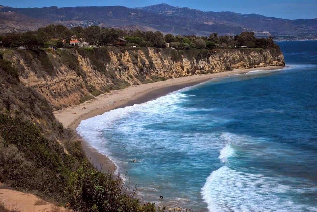 This is called Paradise Cove, a name generously applied to more spots than they deserve. But this one here as being in Malibu can sufficiently be justified at least by the cost of entrance fee. $50 parking fee to visit. It's the most popular surfing spot along with neighboring Zuma Beach for the locals and the likes. But even for them it's $25 a pop. 