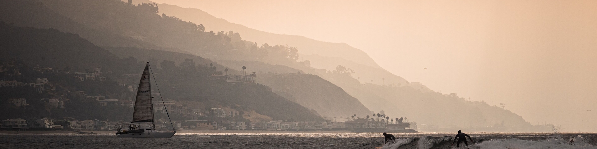 Surfboards and sailboats share the sea as the sun slips above the slopes along Malibu. #adventure #adventure photo contest #surfing #malibu #california #surf spots
