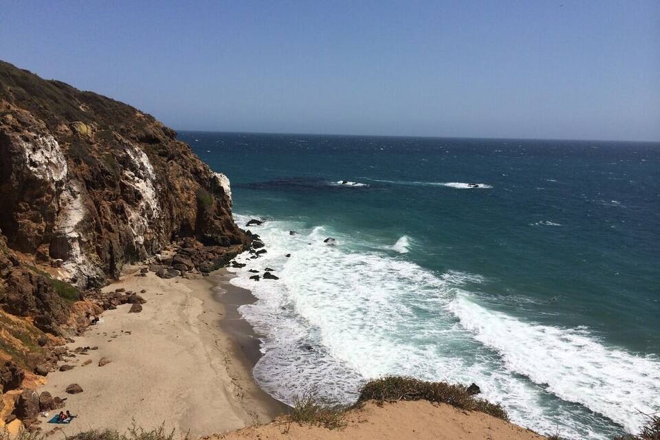 A rocky coastline with waves crashing onto the shore.