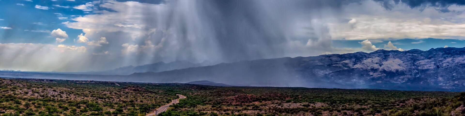 thunderhead cloud produces rain shower over semi-desert grassland prairie