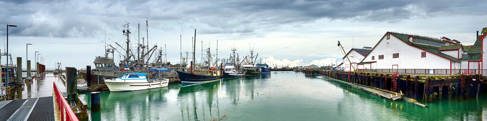 Panoramic view of the Steveston Fisherman's Wharf. Fishing boats and sailboats in Steveston harbor. Richmond, BC, Canada