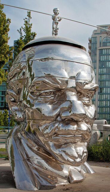 This art work was called "Miss Mao Trying to Poise Herself at the Top of Lenin’s Head" created by Gao Brothers.  It was on display in Richmond during Vancouver biennale celebrations. 
