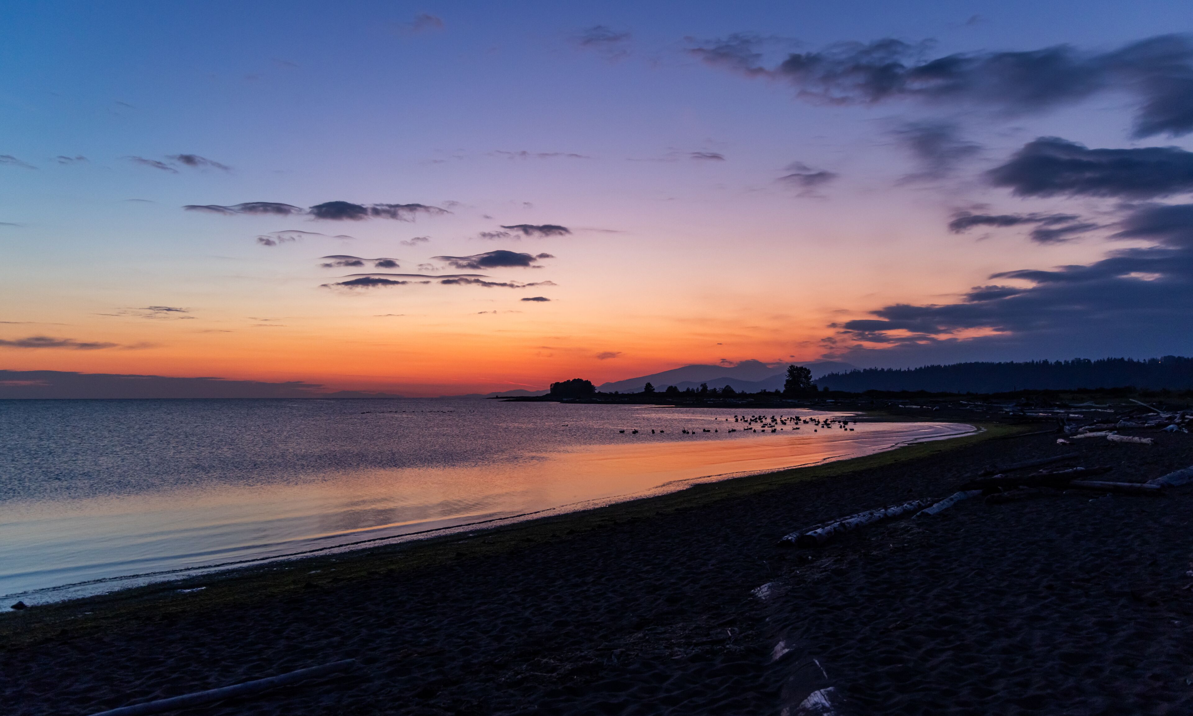 Serene Sunset Over Iona Beach in Greater Vancouver, BC With Distant Hills