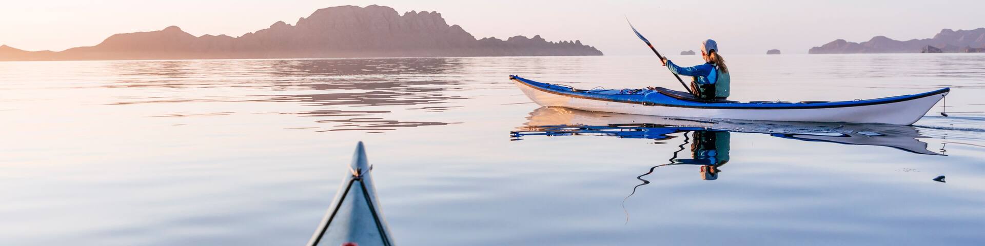 Woman sea kayaking in Bahia de Loreto National Park, Puerto Escondido, Baja California Sur, Mexico