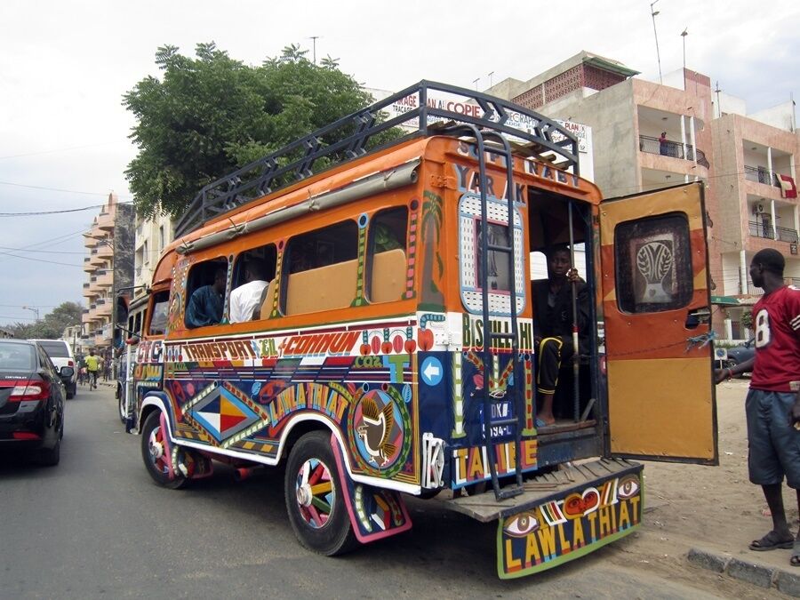 Brightly colored buses in Dakar, but as a tourist, you're better off taking a taxi. 

Take a map with you as many cabbies don't speak English. 