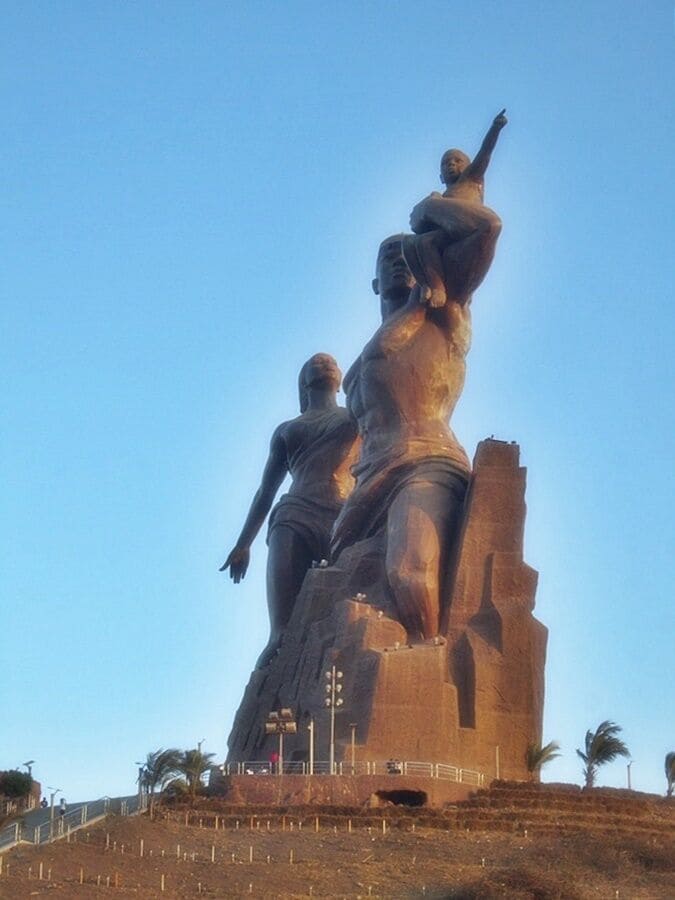 The African Renaissance Monument, completed in 2010 stands 49 meters tall. depicting a young man, guiding his wife and holding his small child facing into the west. The infant points ahead to indicate the glorious future, while the woman extends her arm behind to acknowledge the troubled past.

This bronze statue stands on top of a 100 meter hill overlooking the Atlantic Ocean. It is the tallest statue in Africa and is over one and-a-half times the height of the Statue of Liberty.