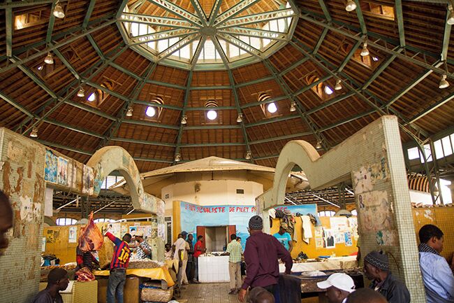 This is a must visit, one of the best of Dakar`s markets! In a beautiful circular building the fish traders has their place in the center. Then comes butchers in the next circle, vegetable and fruit dealers outside there together with florists. Outside the building you will find typical African souvenirs such as jewelry, masks and sculptures. Read more: http://www.travelwithallsenses.com/shopping-dakars-markets/
