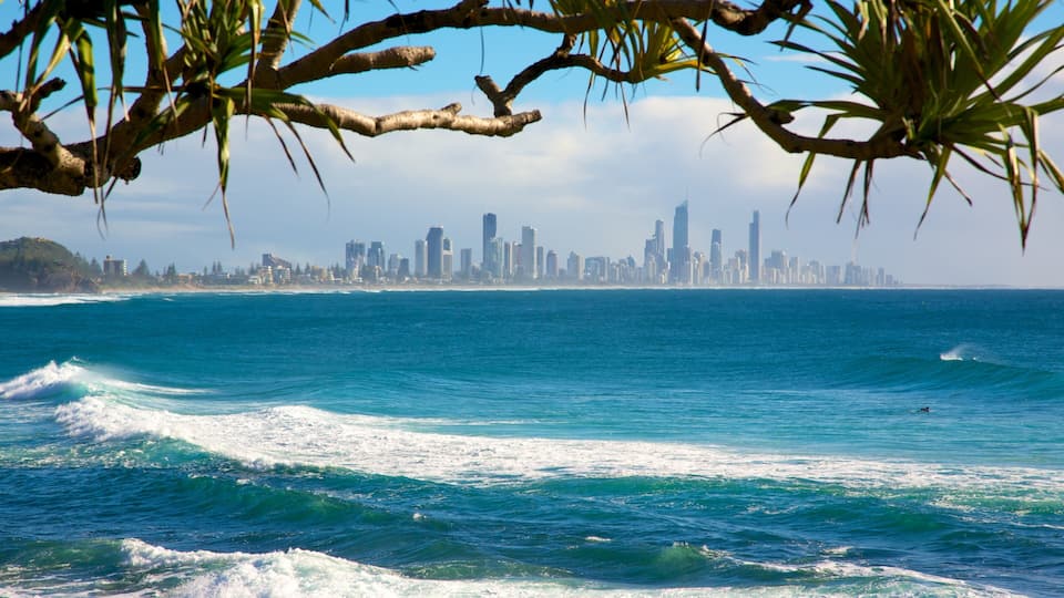 Burleigh Heads featuring waves, a coastal town and a skyscraper