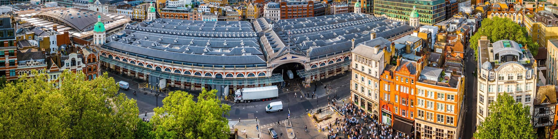 Aerial view of Smithfield Market in London, featuring historic architecture, city streets, and surrounding modern urban buildings