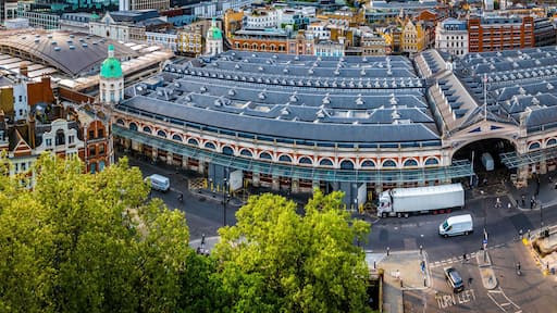 Aerial view of Smithfield Market in London, featuring historic architecture, city streets, and surrounding modern urban buildings