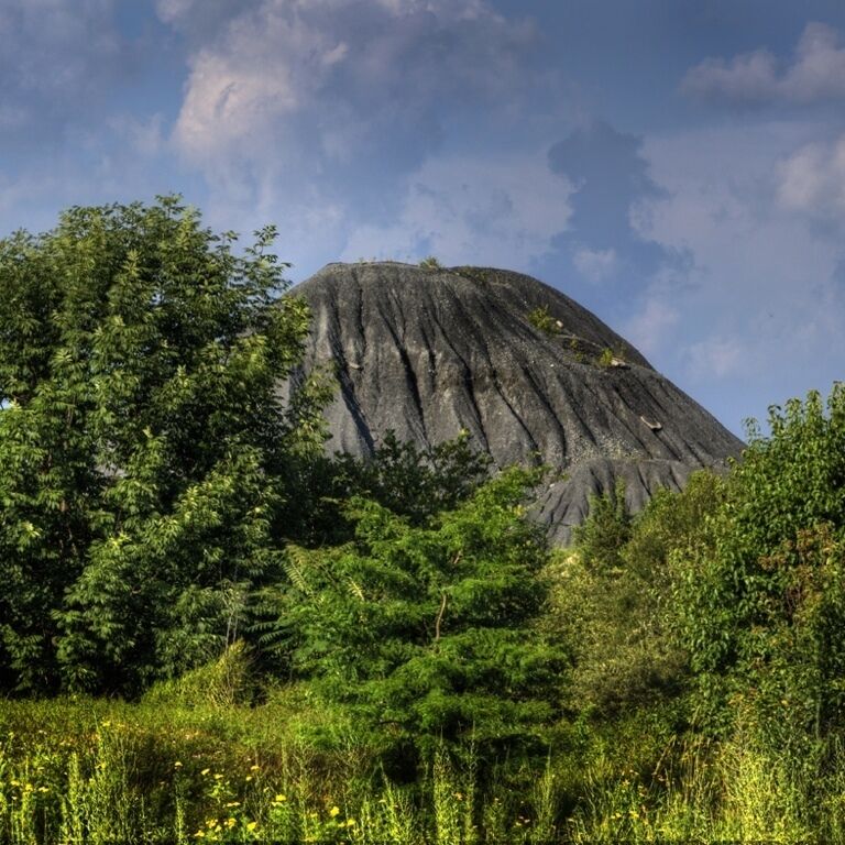 Passing this sand and gravel company, I saw this giant slag heap towering over the foliage, reaching for that blue sky.  But in my mind, I try to imagine it as some volcanic mountain on a distant, far away Pacific island, Iwo Jima perhaps.   